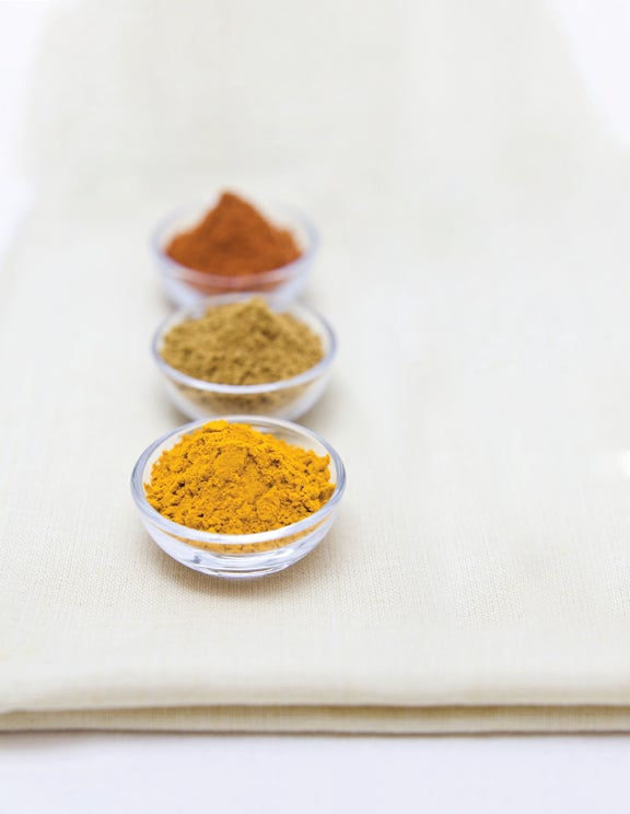 Fresh spices in small bowls (turmeric, garam masal