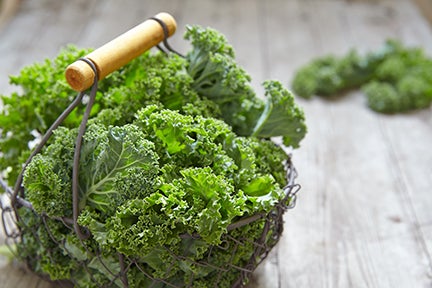 Fresh green kale leaves on wooden table