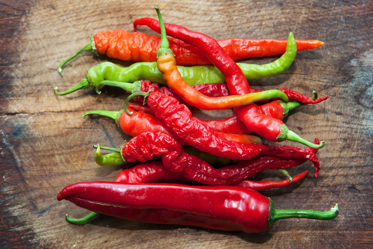 Red  Peppers on the wooden table