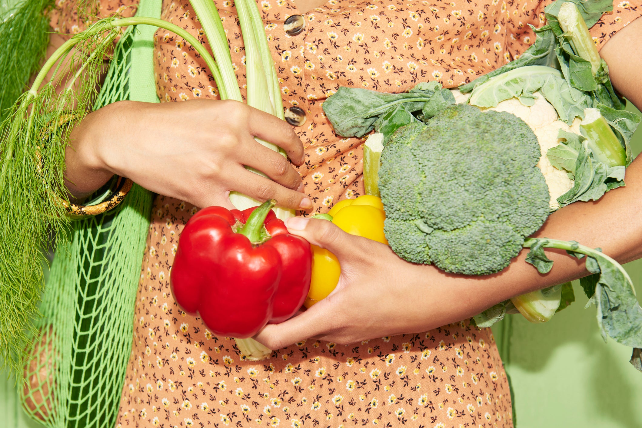 woman holding vegetables to illustrate plant-based diet