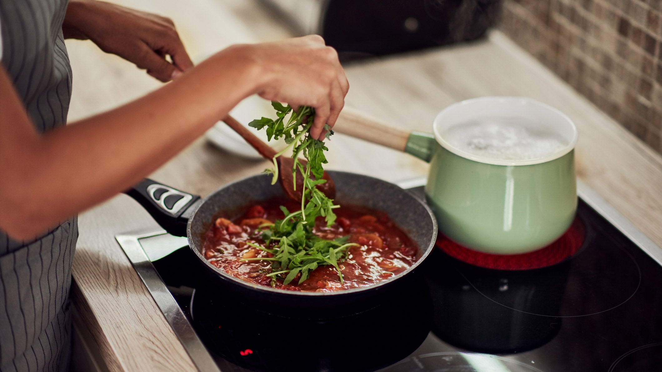 Woman cooking dinner on a stove