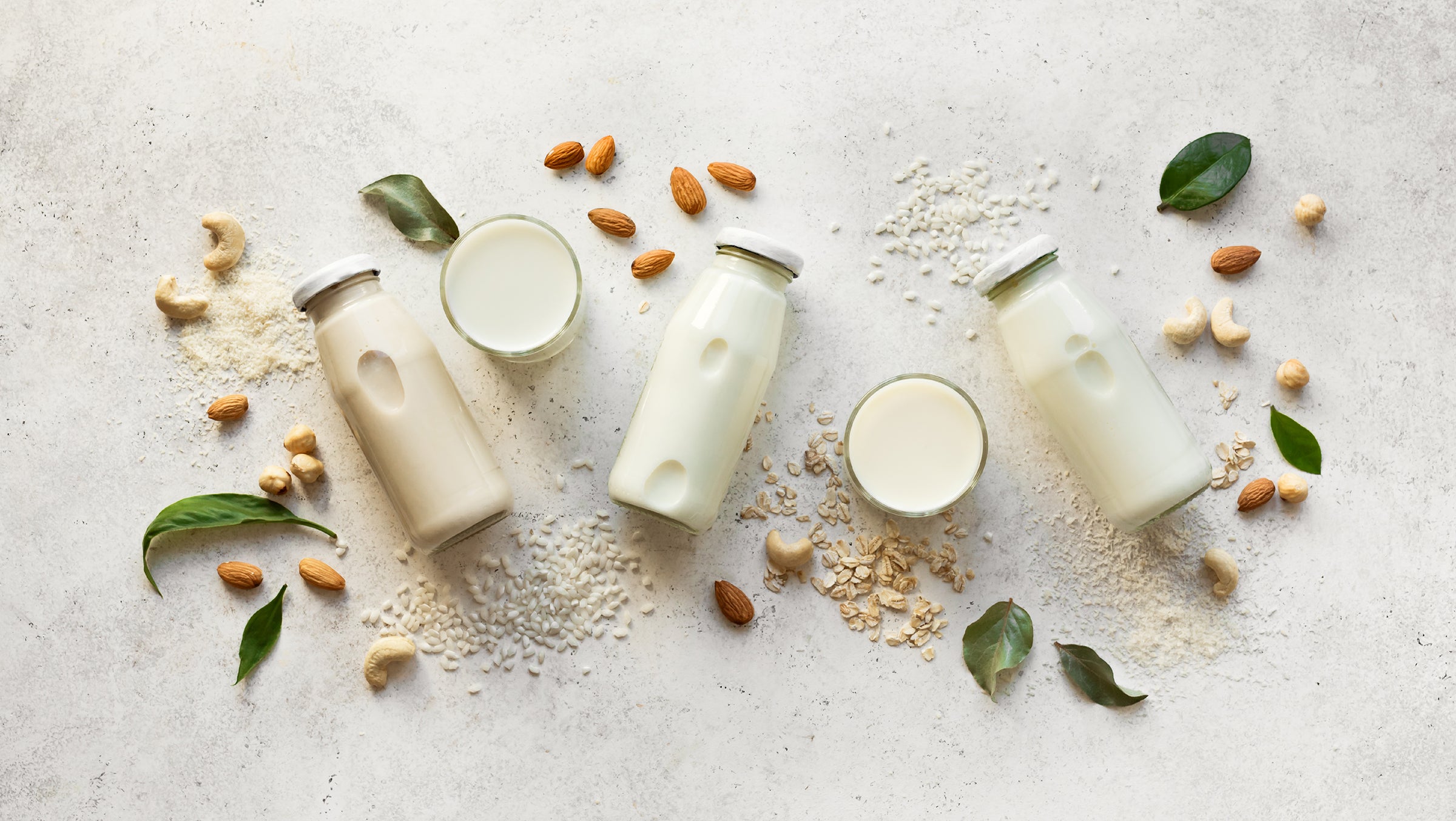 Milks in glass bottles and bowls