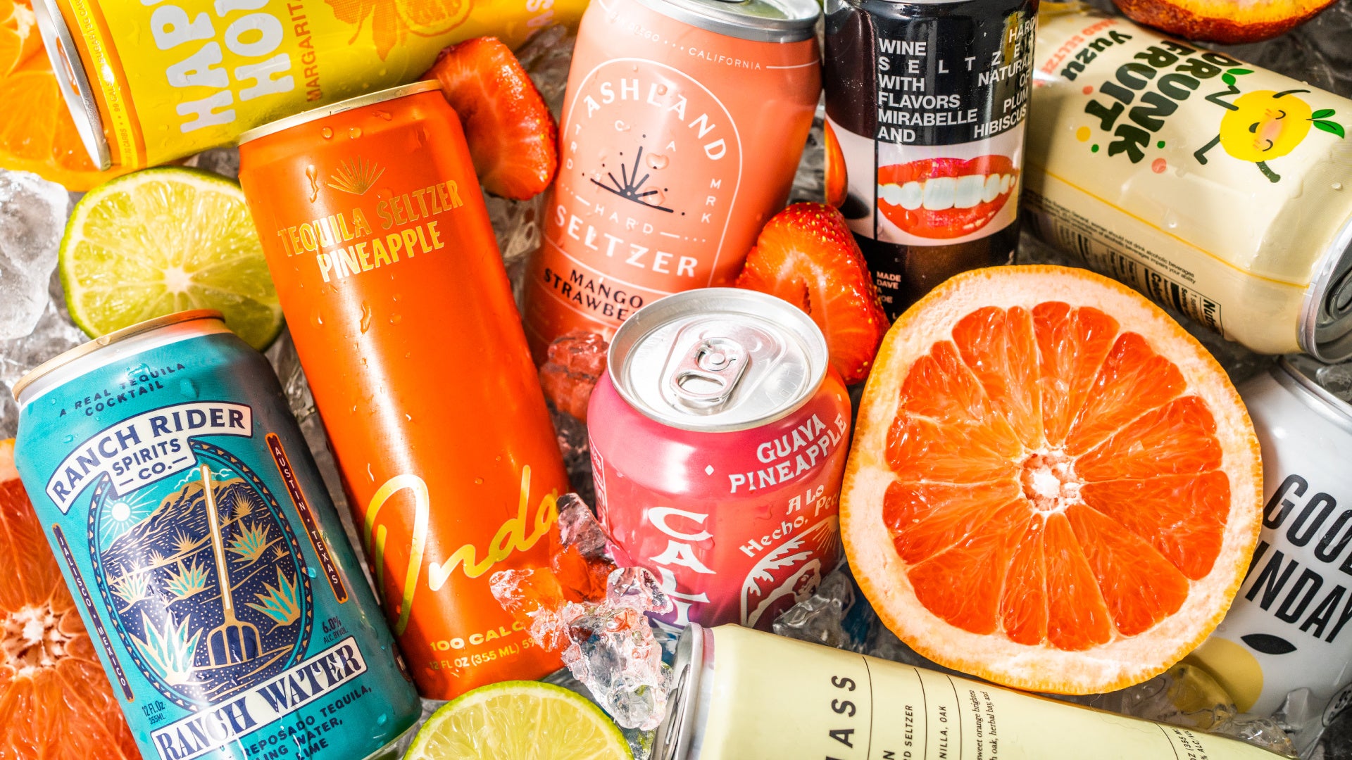 hard seltzer cans sit in ice with fruit